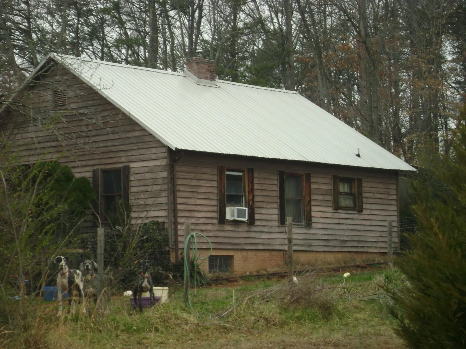 White metal roof on an old wood sided farmhouse, from a Metal Roof Installation job in Footville